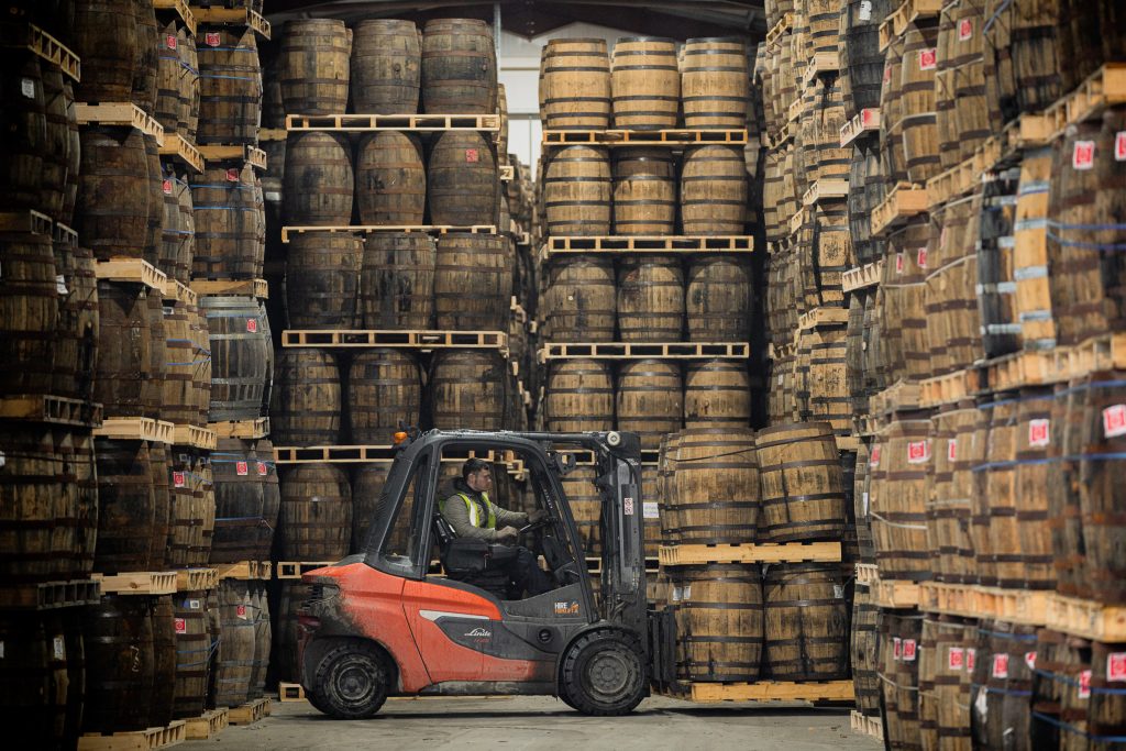 A forklift moving casks through the West Cork Distillers warehouse