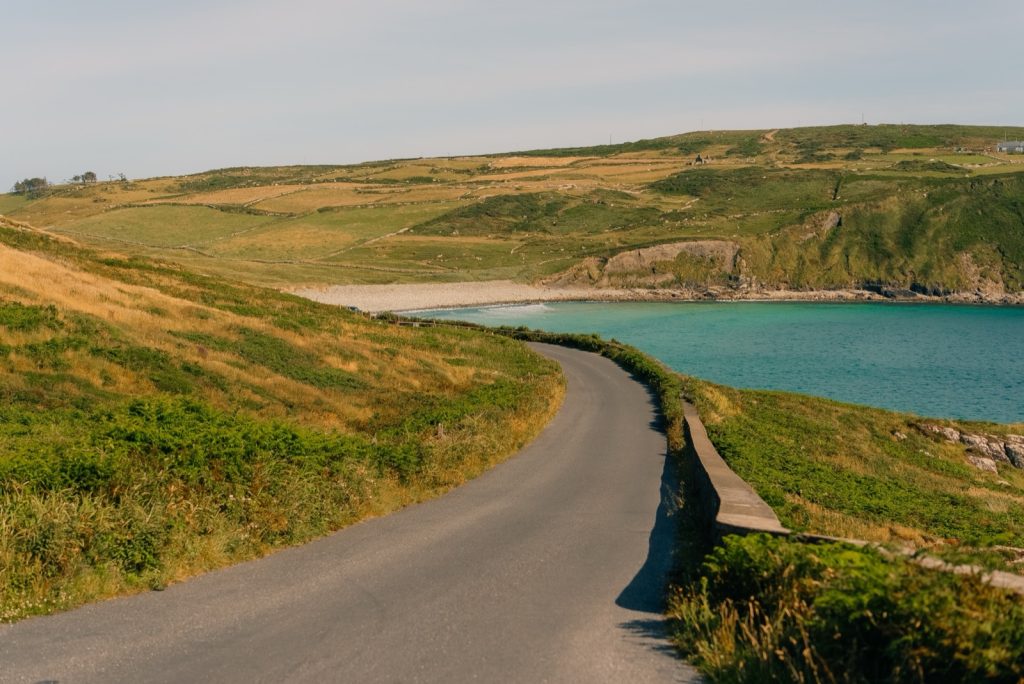 A coastal road winding above a beach in West Cork