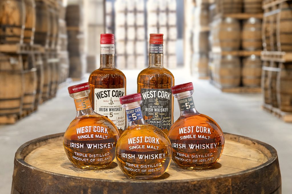 The full West Cork whiskey range on a barrel in the warehouse: Original, Black Cask, Sherry Cask, Rum Cask and Virgin Oak